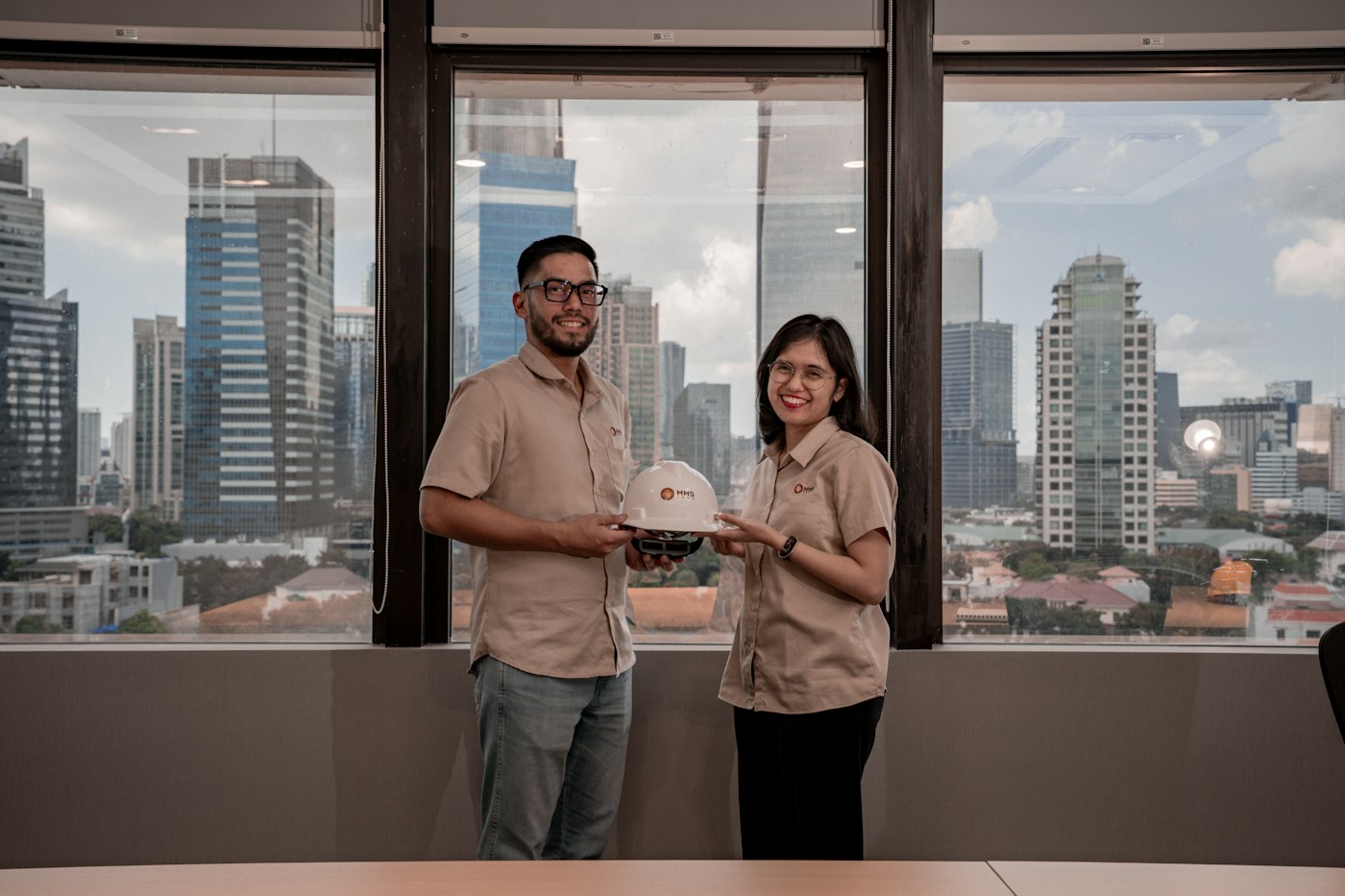 Two professionals holding a safety helmet